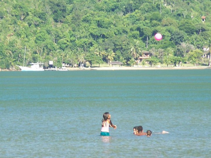 children playing in the waters of the sea channel in mamanguá